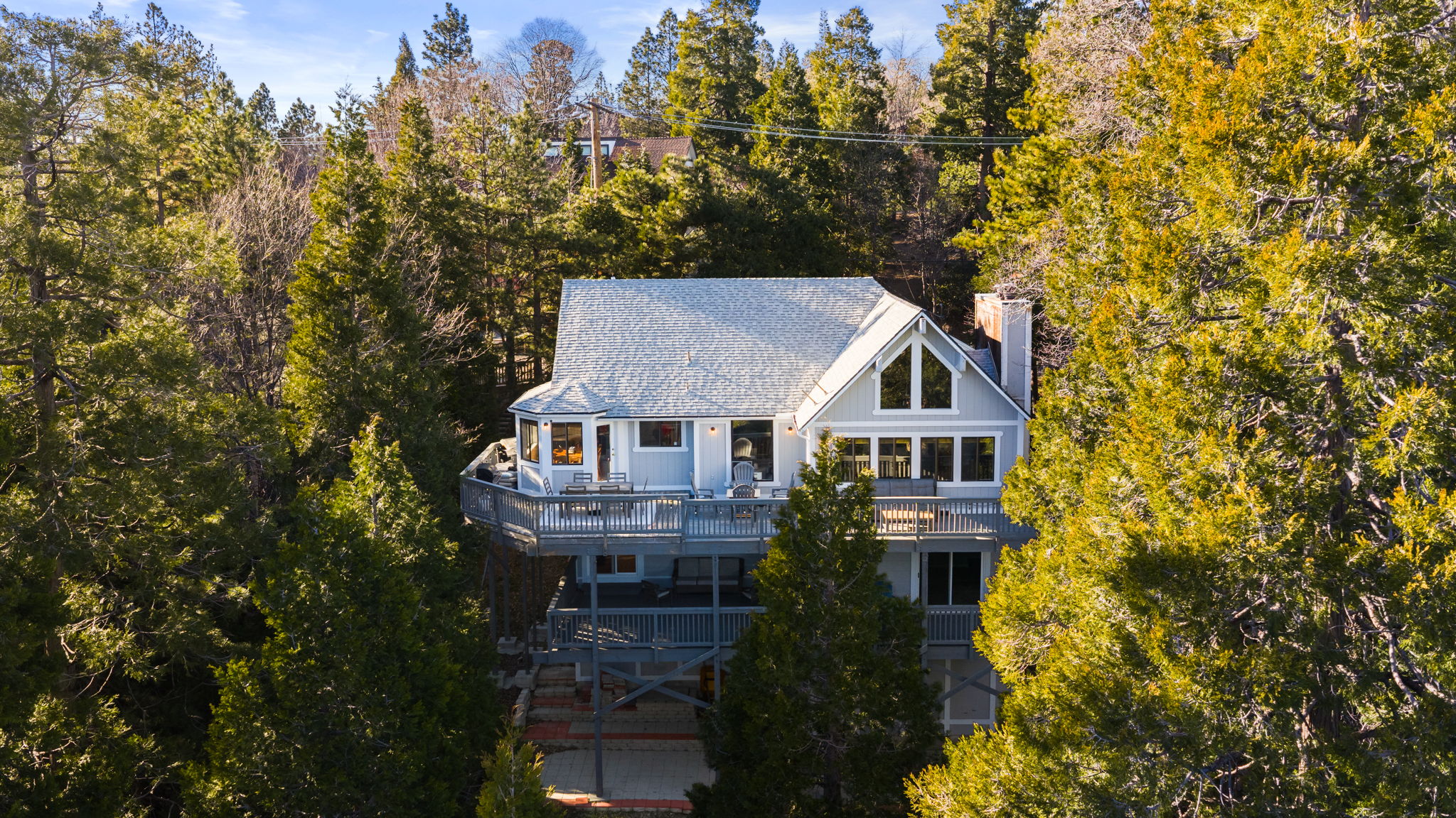 The Lake Arrowhead home surrounded by tall mountain trees